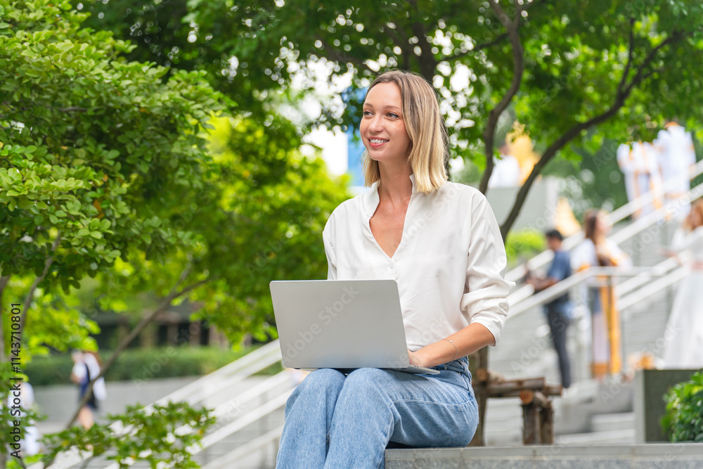 Caucasian Woman Using Laptop to Work While Sitting Outdoor a Park Caucasian Woman Using Laptop to Work While Sitting Outdoor a Park