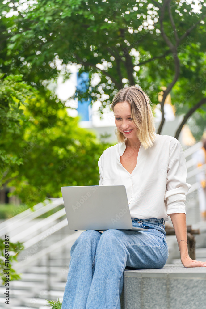 Caucasian Woman Using Laptop to Work While Sitting Outdoor a Park Caucasian Woman Using Laptop to Work While Sitting Outdoor a Park