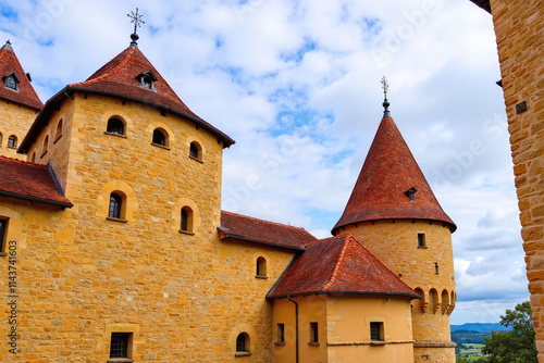 Medieval castle with red roofs against cloudy sky