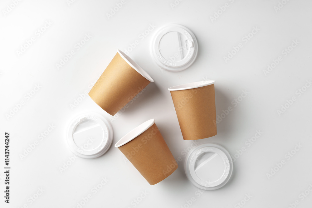 Three disposable coffee cups arranged on a white background Three disposable coffee cups arranged on a white background