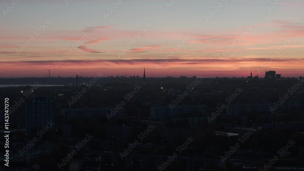 Aerial silhouette of a city buildings and pink sunset in the horizon Aerial silhouette of a city buildings and pink sunset in the horizon