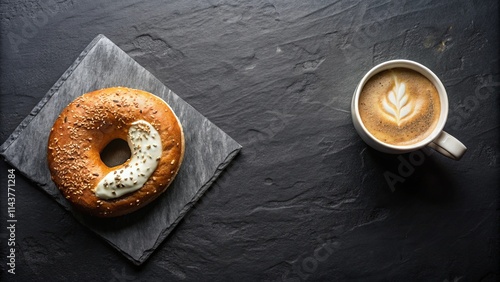 A delicious sesame bagel with cream cheese paired with a cup of latte art coffee on a dark stone background photo