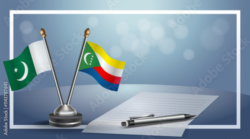 Pakistan and Comoros National flags on small table with bokeh background, cooperative relationship