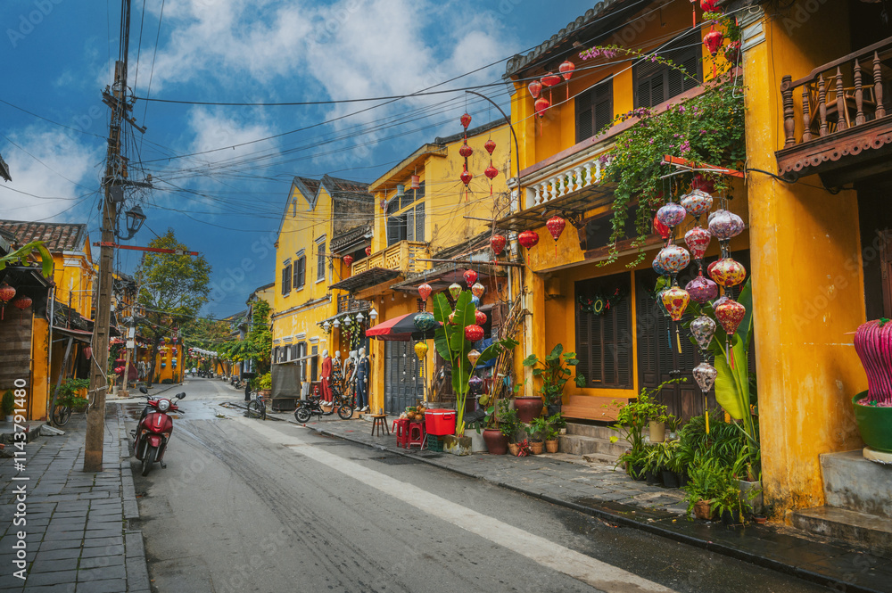 Naklejka premium Streets with traditional old yellow houses decorated with paper lanterns in Hoi An