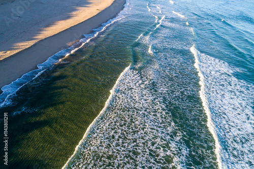 drone aerial view of an uncrowded beach in the morning sun photo