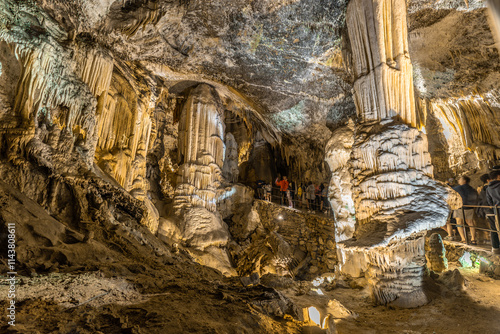 Bild auf Leinwand Tourists visiting the impressive postojna cave in slovenia