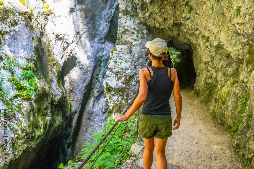 Tourist walking in tolmin gorge canyon in slovenia Tourist walking in tolmin gorge canyon in slovenia