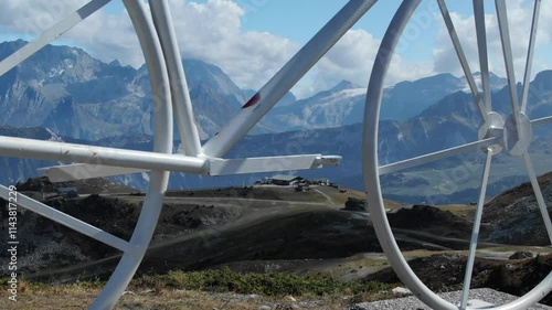 Big white bicycle called bike climb, alpine landscape, Col de la Loze summit in French Alps, Meribel in Savoie department of France. Aerial drone lateral view photo