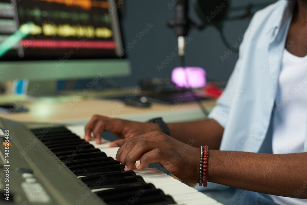 Obraz premium Close-up of musician playing piano in recording studio
