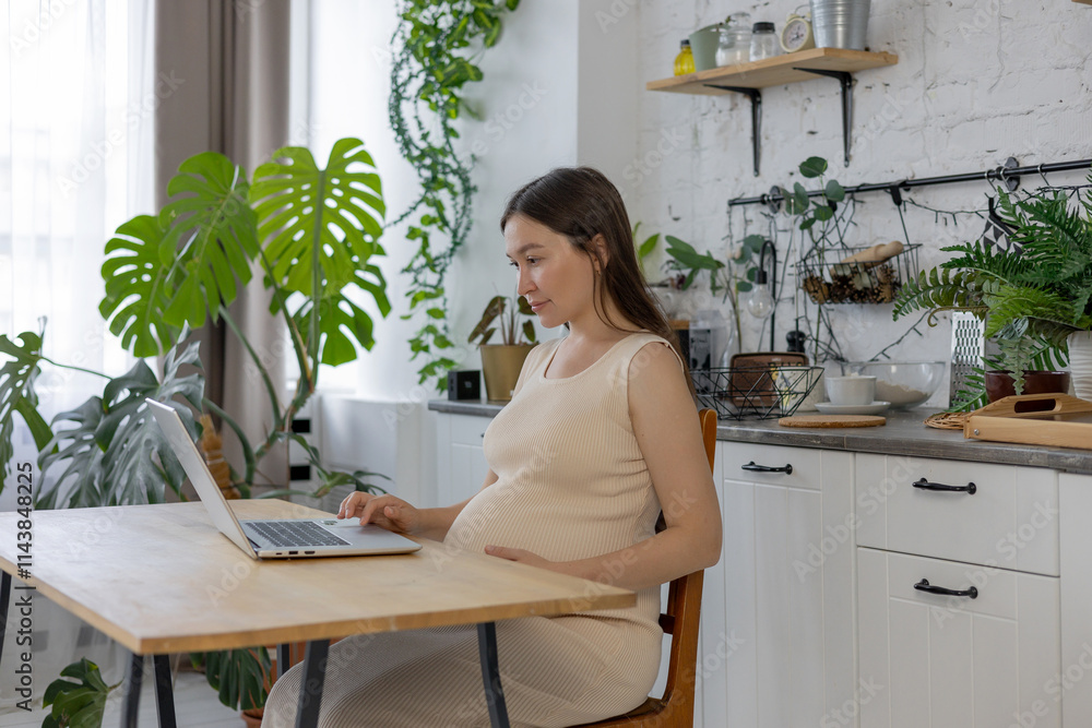 pregnant woman sitting with laptop at home. pregnant woman working or studying online pregnant woman sitting with laptop at home. pregnant woman working or studying online
