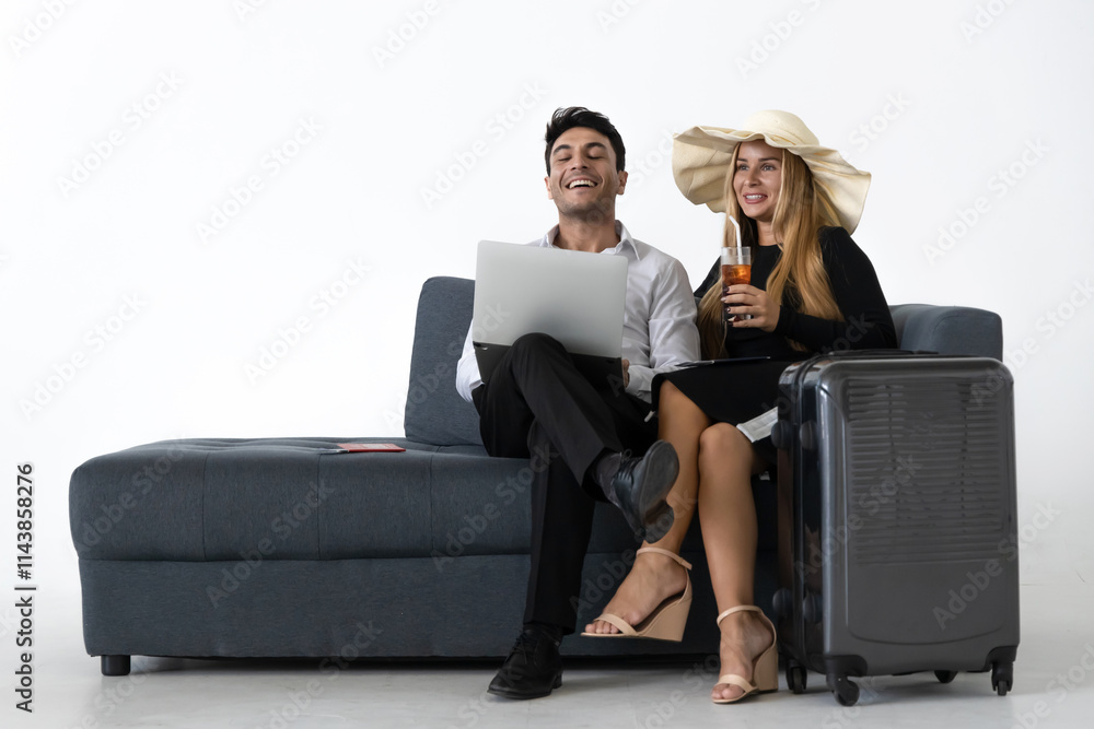 Obraz premium Relaxed happy couple sitting and planning vacations trip on couch over white background. Summer vacation concept.