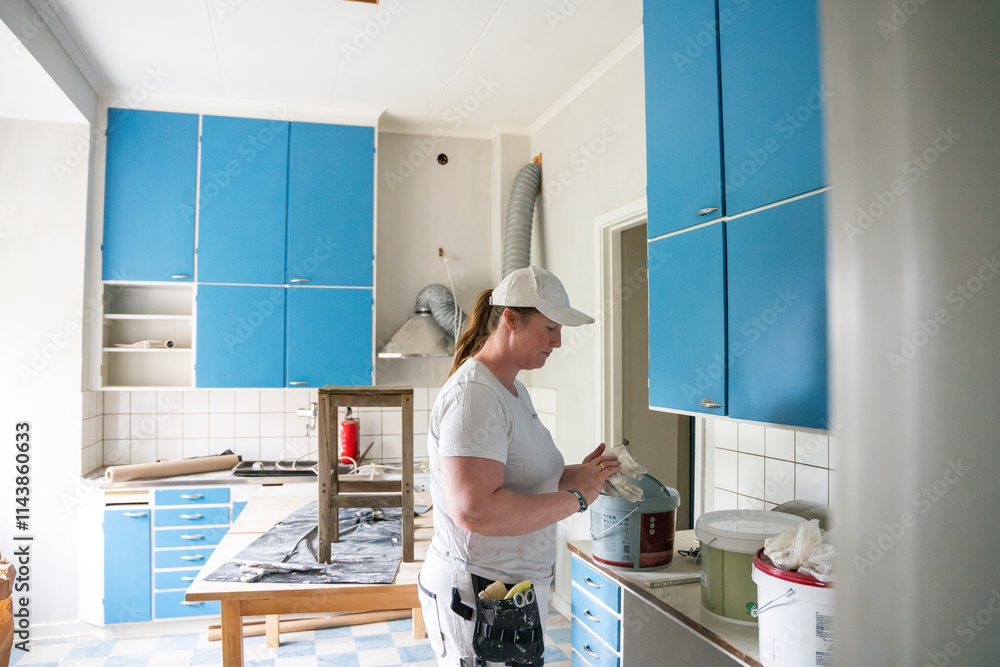 Side view of female painter wearing gloves at workplace Side view of female painter wearing gloves at workplace