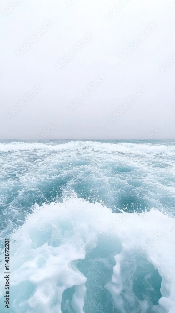 Fototapeta premium Tranquil Ocean Waves with Soft Foam Against a Calm Horizon in a Serene Coastal Landscape Under Overcast Sky