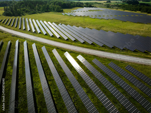 Drone point of view of empty road amidst solar panels farm photo