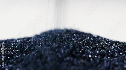 Abrasive powder is poured on the table