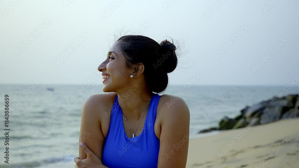 Young attractive Asian girl practice yoga pose on the beach. Confident fit women practicing meditation ,Concept of well being, healthy balanced lifestyle.