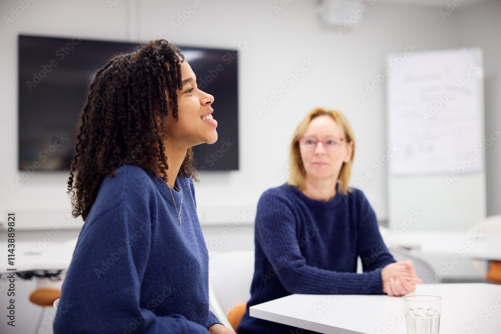 Medical student talking with healthcare worker during interview in office Medical student talking with healthcare worker during interview in office