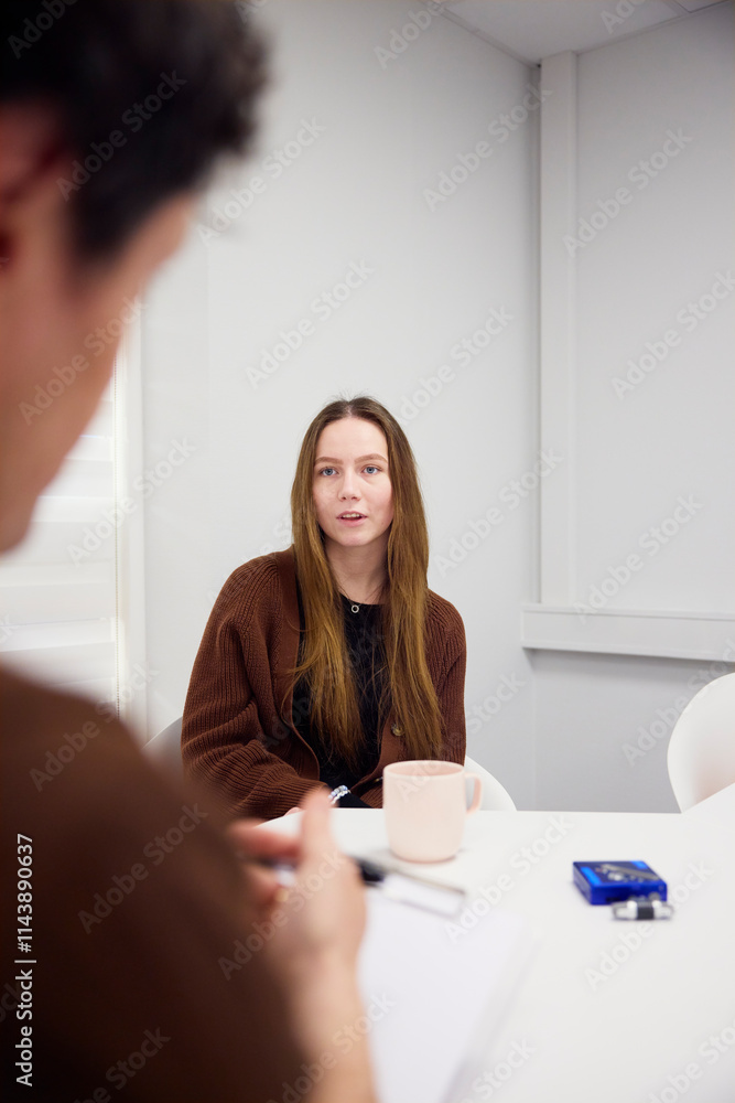 Male healthcare worker conducting interview of medical student Male healthcare worker conducting interview of medical student