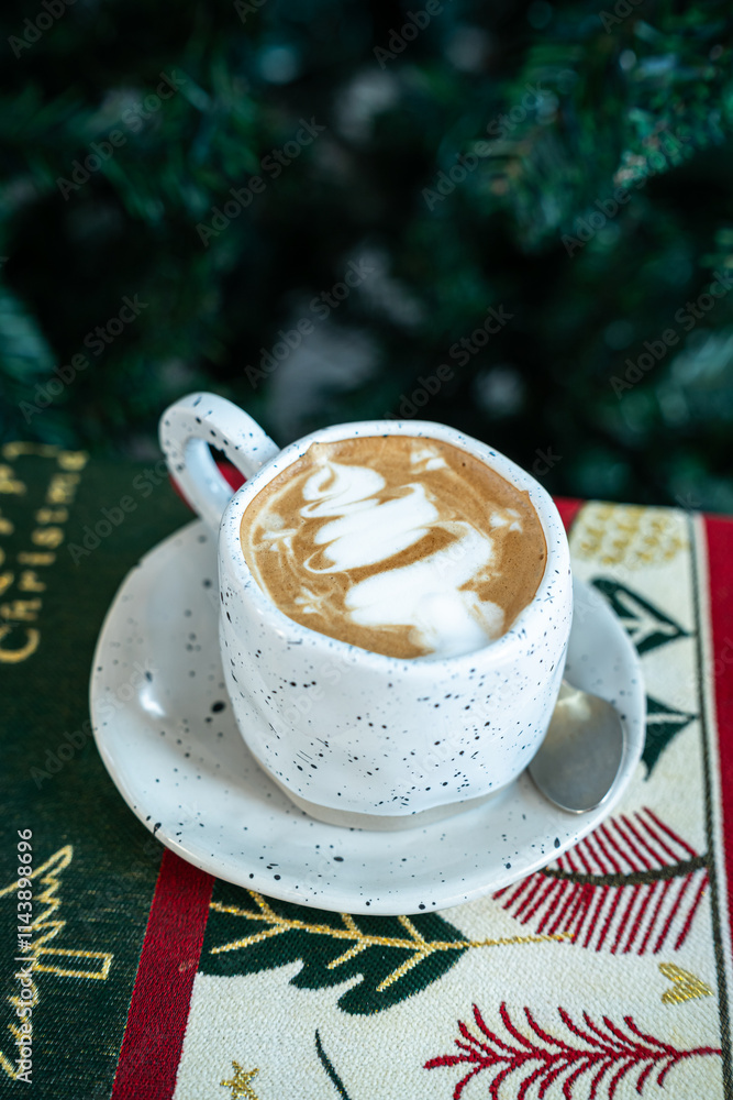 Close up of Hot coffee latte with latte art milk foam in cup mug with Xmas decors and Xmas tree baubles on wood desk Celebrating Merry Christmas and New year,Merry x-mas