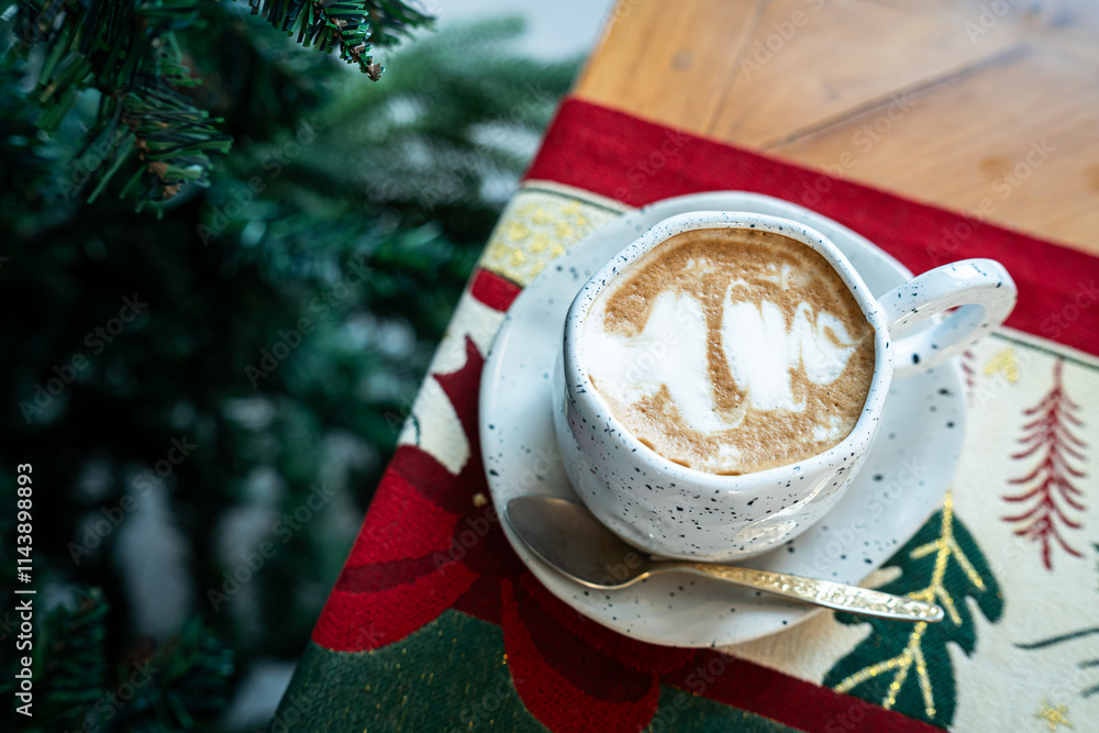 Close up of Hot coffee latte with latte art milk foam in cup mug with Xmas decors and Xmas tree baubles on wood desk Celebrating Merry Christmas and New year,Merry x-mas