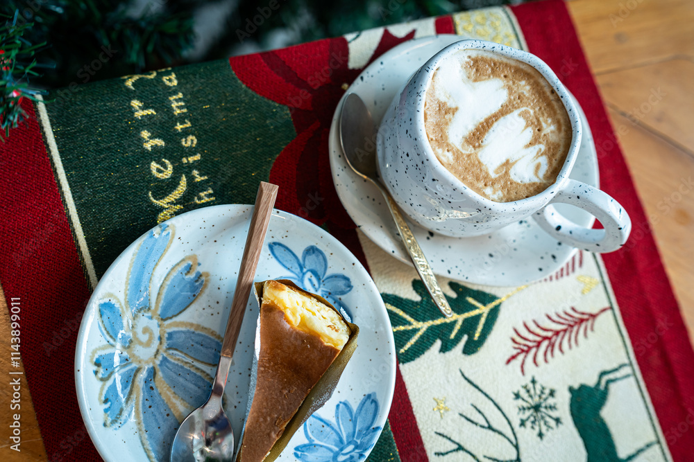 Close up of Hot coffee latte with latte art milk foam in cup mug and Homemade burnt cheesecake with Xmas decors and Xmas tree baubles on wood desk Celebrating Merry Christmas and New year,Merry x-mas