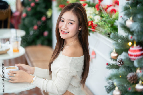 Obraz na płótnie Portrait beautiful asian woman holding of positive the having cup of coffee,milk or chocolate at home in the living room indoors Decoration During Christmas x-mas and New Year holidays. w salonie