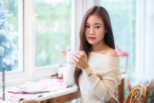Obraz na płótnie Portrait beautiful asian woman holding of positive the having cup of coffee,milk or chocolate at home in the living room indoors Decoration During Christmas x-mas and New Year holidays. w salonie