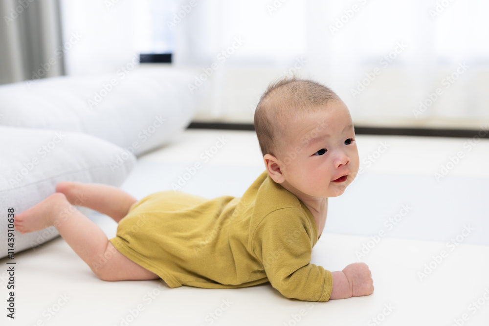 Adorable baby lying on cozy play mat indoors Adorable baby lying on cozy play mat indoors