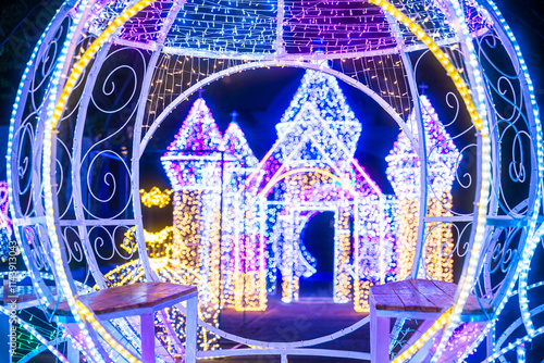 Obraz na płótnie PHITSANULOK, THAILAND - December 15,2024:Decoration lights Christmas tree for celebrate Christmas and New Year Festival 2025 illumination at Saint Nicholas School in Phitsanulok City at night w salonie