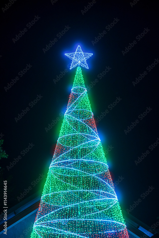 PHITSANULOK, THAILAND - December 15,2024:Decoration lights Christmas tree for celebrate Christmas and New Year Festival 2025 illumination at Saint Nicholas School in Phitsanulok City at night