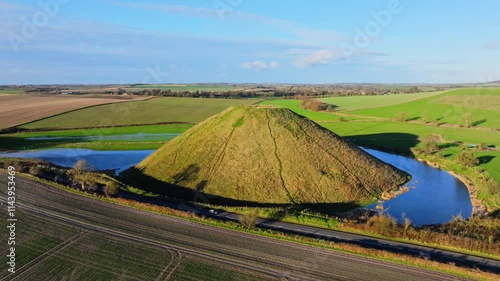 High aerial shot of Silbury hill with low winter sun and long shadows photo