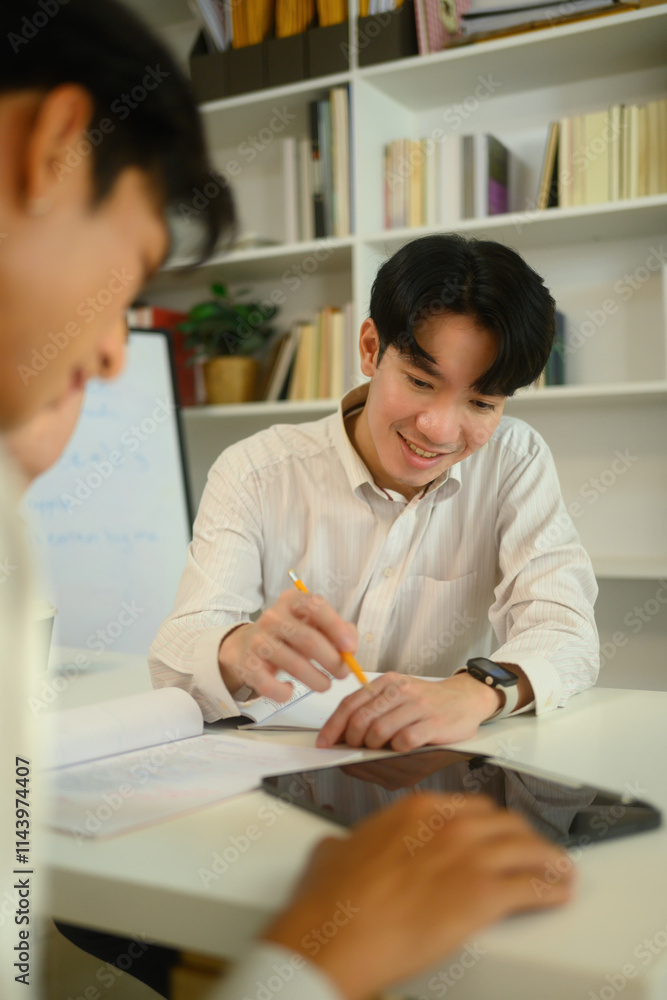 Smiling male tutor guiding student during a personalized study session