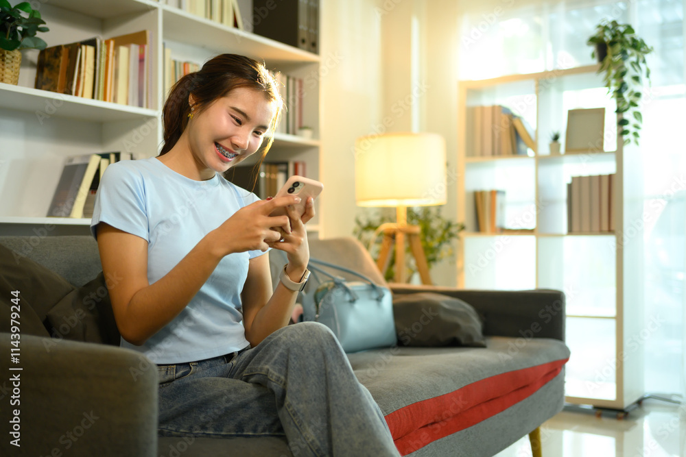 Attractive young woman typing text message on her mobile phone