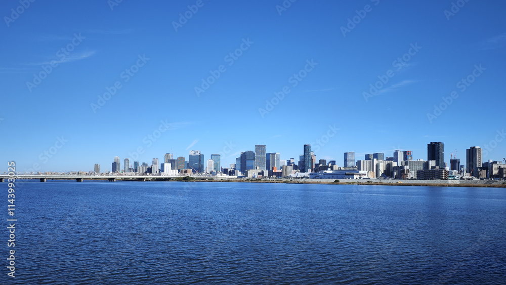 Fototapeta premium Yodo River at Osaka Umeda modern buildings japanese city skyline with clear blue sky
