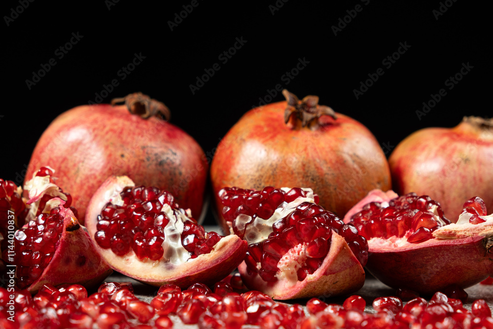 Ripe pomegranates, peeled and whole, the concept of benefits and vitamins in fruit. Ripe pomegranates, peeled and whole, the concept of benefits and vitamins in fruit.