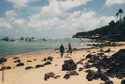 Scenic beach view with boats and people.