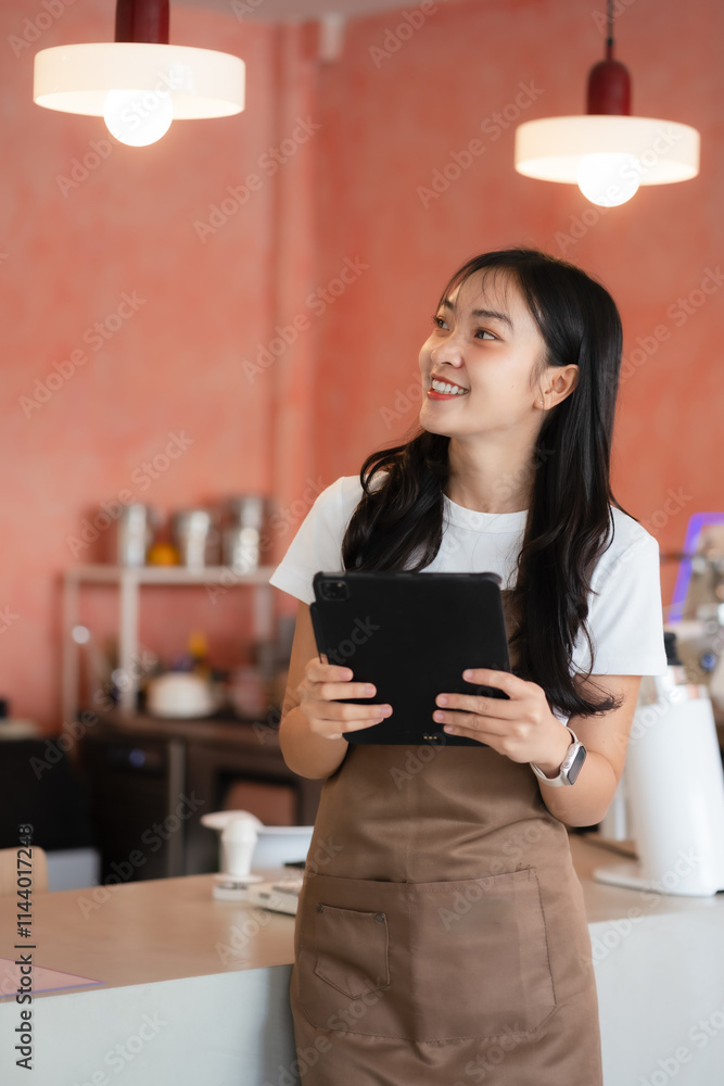 Asian female barista wear apron at counter bar with smile face, cafe service concept, owner business start up. Asian female barista wear apron at counter bar with smile face, cafe service concept, owner business start up.