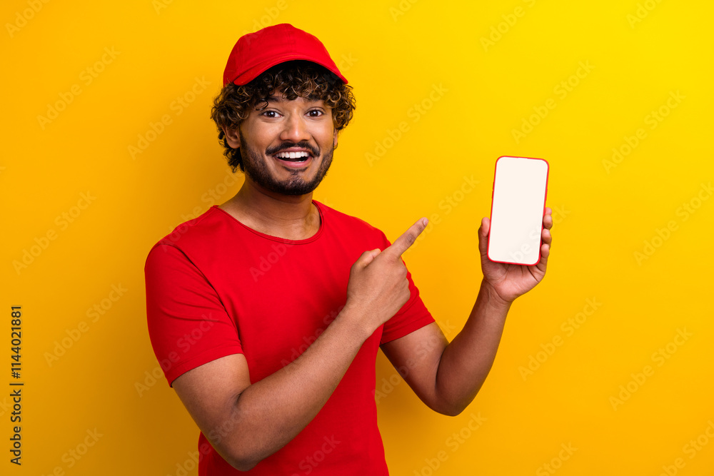 Happy delivery worker smiling while featuring a blank smartphone screen. Happy delivery worker smiling while featuring a blank smartphone screen.