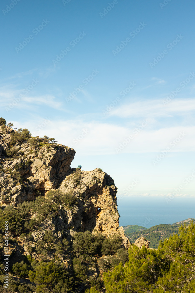 Vertical image of amazing elephant shaped rock mountain on a sunny day with a blue sky and the sea in the background Vertical image of amazing elephant shaped rock mountain on a sunny day with a blue sky and the sea in the background