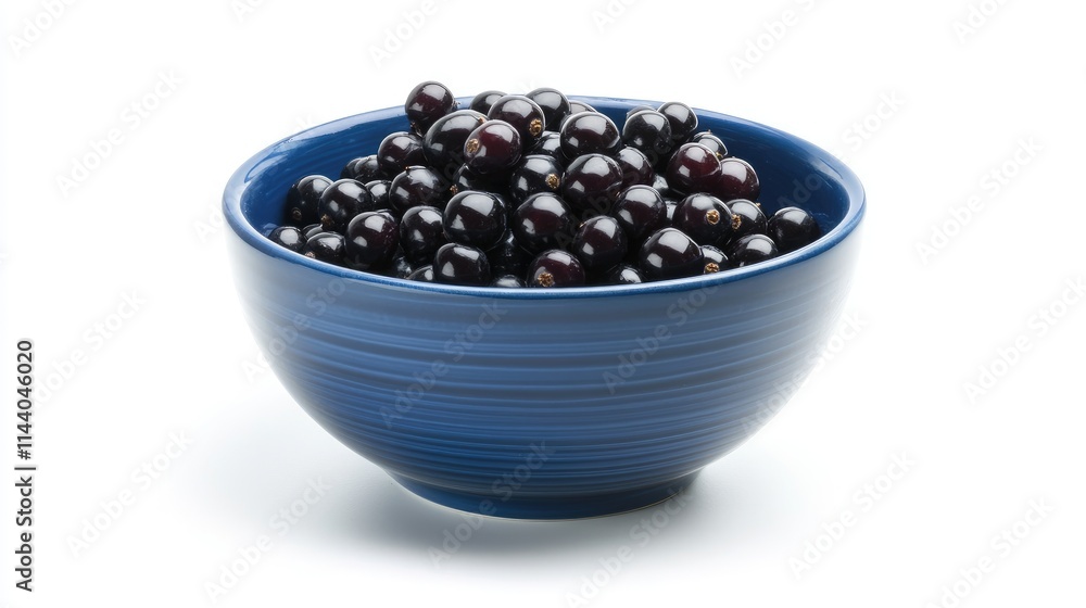 Freshly harvested black currants in a vibrant blue bowl showcasing their rich color and texture against a clean white background Freshly harvested black currants in a vibrant blue bowl showcasing their rich color and texture against a clean white background