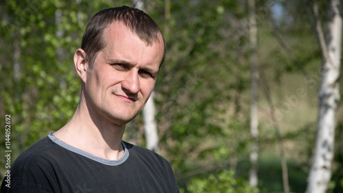 man portrait. the guy against the backdrop of nature. photo, smiling, thoughtful, surprised, indignant, feelings, emotions. fair skin, slight stubble. man 30-40 years old. close-up. European photo