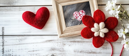 Handmade felt flower and heart on wooden background with photo frame symbolizing spring love and the joy of creative needlework photo