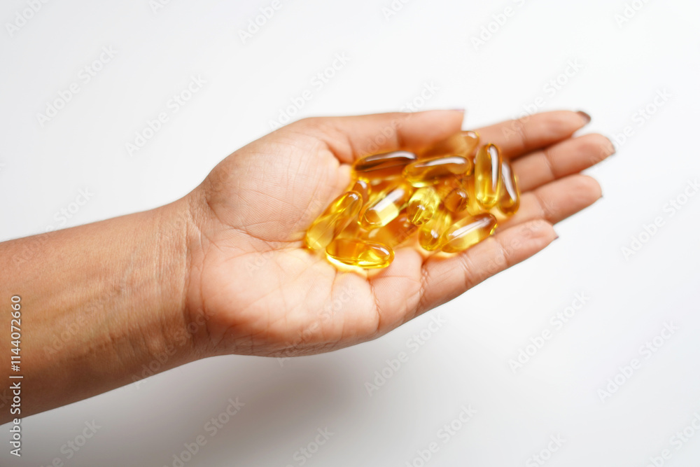 healthy concept image of hand on fish oil capsules healthy concept image of hand on fish oil capsules