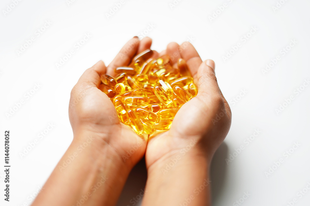 hand holding omega 3 capsules, fish oil hand holding omega 3 capsules, fish oil