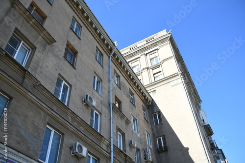 Architecture of old Soviet Union houses in Stalin's Empire style. Exterior of the facade of a vintage residential building in Russia