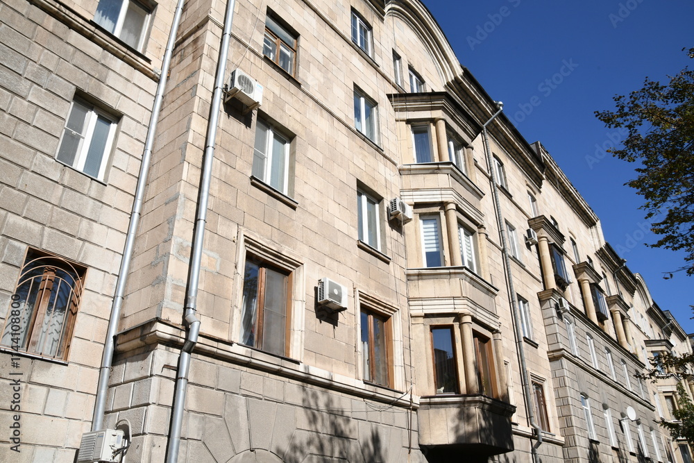 Fototapeta premium Architecture of old Soviet Union houses in Stalin's Empire style. Exterior of the facade of a vintage residential building in Russia