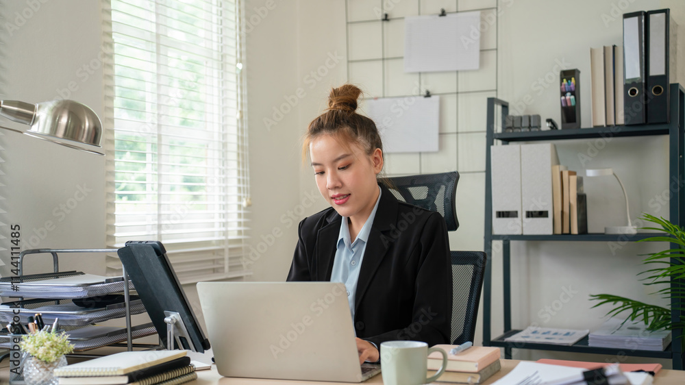 Businesswoman sitting at desk on couch in workplace or at home working on laptop and analyzing data on charts and graphs and writing on papers to make business plan and strategies for company, Businesswoman sitting at desk on couch in workplace or at home working on laptop and analyzing data on charts and graphs and writing on papers to make business plan and strategies for company,