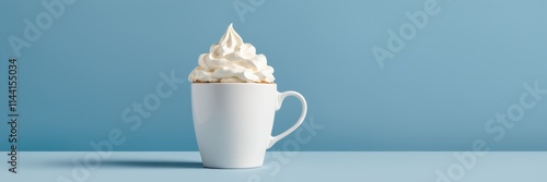 White mug holds whipped cream against blue background