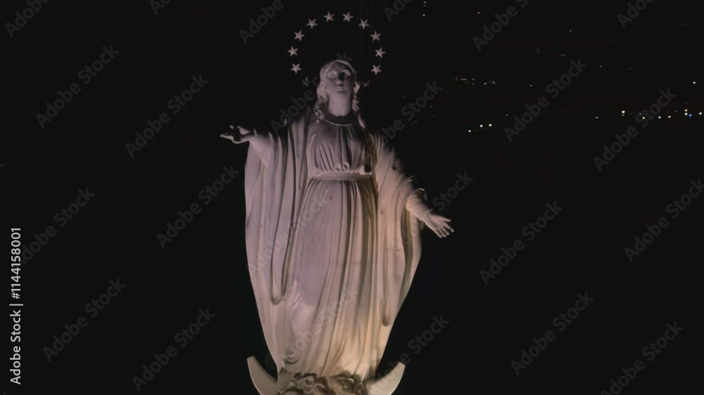 View from the air at night, of the Virgin of San Cristobal Hill, in Bella Vista Santiago de Chile, the Immaculate Conception, an orbit of the sculpture is made View from the air at night, of the Virgin of San Cristobal Hill, in Bella Vista Santiago de Chile, the Immaculate Conception, an orbit of the sculpture is made