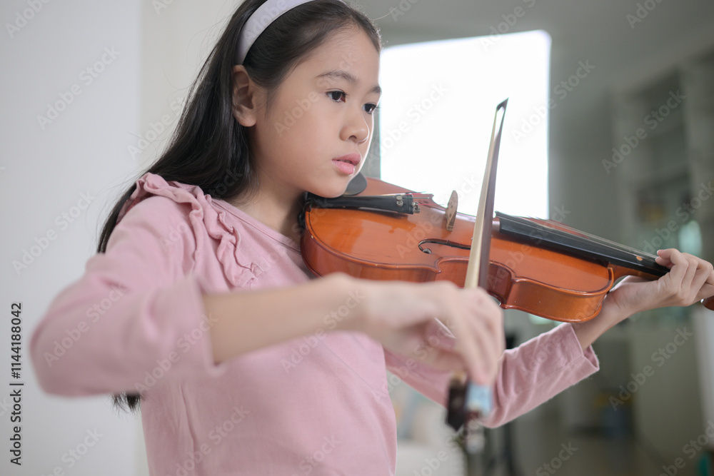 A girl violinist plays and practices the violin at home A girl violinist plays and practices the violin at home